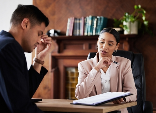 What Are The 7 Critical Steps To Take Within 24 Hours Of A Phoenix Domestic Violence Incident? Arizona domestic violence attorney with client reviewing case